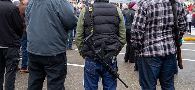 Men with long guns at a protest at the Capitol Campus in Olympia.