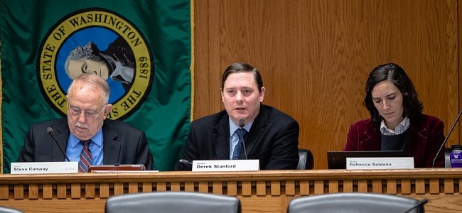 Senators Steve Conway, Derek Stanford and Rebecca Saldana listen during testimony in a committee hearing in Olympia